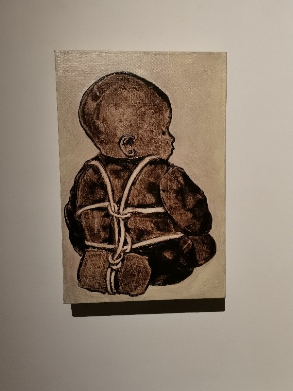 The Mother & The Weaver Marginalia (Baby with Weight), 1992 Ida Applebroog (b.1929) Oil and resin on canvas '[The subject of my work is] how power works - male over female, parents over children, governments over people, doctors over patients.' This disturbing image depicts a baby, physically bound and weighted, which makes symbolic reference to an abuse of power. Viewed from behind, the angle emphasises the child's vulnerability. The detail of the weight might suggest the presence of an emotional burden, or it could have more sinister connotations. This painting is from an extended and open-ended series called Marginalias (or 'notes in the margin'), though each painting is a stand-alone work. Applebroog embraces the new meanings that changes of contexts provide.
